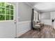 Comfortable sitting room with hardwood floors, paneled walls, and plenty of natural light at 4524 Shumart Dr, Snellville, GA 30039