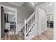 Hallway showcasing a carpeted staircase with white wood railing and trim at 4524 Shumart Dr, Snellville, GA 30039