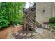 Exterior view of a home and backyard featuring landscaping, stairs, deck and a patio with firepit at 4674 Lakeway Pl, Alpharetta, GA 30005