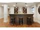 Finished basement bar featuring a granite countertop, dark cabinets, pendant lighting and three barstools at 4674 Lakeway Pl, Alpharetta, GA 30005
