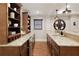 Entertainer's bar with granite countertops, mini fridge, custom cabinets and a unique film reel decoration at 4674 Lakeway Pl, Alpharetta, GA 30005