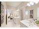 Bright bathroom featuring double sinks with white cabinets and elegant fixtures, leading into the main bedroom at 4674 Lakeway Pl, Alpharetta, GA 30005