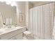 Well-lit bathroom with white vanity, framed art and white shower curtain at 4674 Lakeway Pl, Alpharetta, GA 30005
