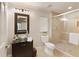 Modern bathroom features glass bowl sink, decorative mirror, toilet, and glass enclosed shower at 4674 Lakeway Pl, Alpharetta, GA 30005