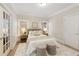Serene bedroom with neutral tones, plush bedding, and soft lighting, creating a peaceful and inviting atmosphere at 4674 Lakeway Pl, Alpharetta, GA 30005