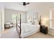 Well-lit bedroom with a four-poster bed, neutral colors, and large windows with charming window shutters at 4674 Lakeway Pl, Alpharetta, GA 30005