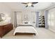 Cozy bedroom with neutral tones, ceiling fan, a decorative ladder shelf and a round mirror at 4674 Lakeway Pl, Alpharetta, GA 30005