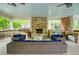 Inviting covered patio with stone fireplace, stainless steel grill and comfortable wicker seating at 4674 Lakeway Pl, Alpharetta, GA 30005