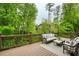 Spacious deck is set with outdoor seating and a wooded backyard view at 4674 Lakeway Pl, Alpharetta, GA 30005