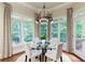 Dining area is set with glass top table and seating, near windows with backyard views at 4674 Lakeway Pl, Alpharetta, GA 30005
