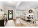 Dining room with hardwood floors, elegant lighting, fireplace, and large windows with shutters at 4674 Lakeway Pl, Alpharetta, GA 30005