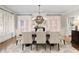 Bright dining room featuring a fireplace, large table with seating for six, and shuttered windows at 4674 Lakeway Pl, Alpharetta, GA 30005