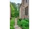 Stone and brick exterior detail with lush landscaping and a private backyard path at 4674 Lakeway Pl, Alpharetta, GA 30005