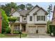 Charming two-story home with brick and shake siding, attached two-car garage, and well-manicured lawn at 4674 Lakeway Pl, Alpharetta, GA 30005