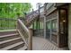 Multi-story deck with staircase leading to the backyard and screened porch with wooded view at 4674 Lakeway Pl, Alpharetta, GA 30005