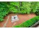 Backyard fire pit featuring white Adirondack chairs and a pea gravel base surrounded by natural landscaping at 4674 Lakeway Pl, Alpharetta, GA 30005