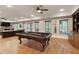 Finished basement game room features a pool table, TV, fireplace, and built-in shelving at 4674 Lakeway Pl, Alpharetta, GA 30005