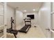 Home gym featuring a treadmill, weight bench, TV, and ample space for fitness activities at 4674 Lakeway Pl, Alpharetta, GA 30005