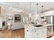 Open-concept kitchen featuring a large island with granite countertops, stainless steel appliances, and hardwood flooring at 4674 Lakeway Pl, Alpharetta, GA 30005