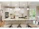 Kitchen island with white cabinetry, granite countertop, pendant lighting, and seating for four at 4674 Lakeway Pl, Alpharetta, GA 30005