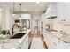 Bright kitchen features granite countertops, stainless steel appliances, white cabinetry, and view to dining at 4674 Lakeway Pl, Alpharetta, GA 30005