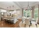 Bright kitchen with white cabinets, granite countertops, stainless steel appliances, and an adjacent dining area at 4674 Lakeway Pl, Alpharetta, GA 30005