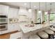 Bright kitchen with granite countertops, stainless steel appliances, white cabinetry, and pendant lights at 4674 Lakeway Pl, Alpharetta, GA 30005