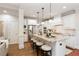 Bright kitchen features a granite island with seating, stainless appliances, and white cabinetry at 4674 Lakeway Pl, Alpharetta, GA 30005