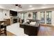 Cozy living room in basement with fireplace, large sectional and a walkout to the backyard at 4674 Lakeway Pl, Alpharetta, GA 30005