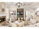 Cozy living room with a stone fireplace, coffered ceiling, hardwood floors, and comfortable neutral furniture at 4674 Lakeway Pl, Alpharetta, GA 30005