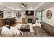 Basement living area with a stone fireplace, large leather sectional, and a bar for entertaining at 4674 Lakeway Pl, Alpharetta, GA 30005