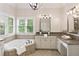 Beautiful bathroom featuring soaking tub, dual vanities, granite countertops, and ample light at 4674 Lakeway Pl, Alpharetta, GA 30005