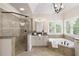 Elegant bathroom featuring glass shower, soaking tub, modern fixtures, and natural light at 4674 Lakeway Pl, Alpharetta, GA 30005