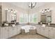 Bright main bathroom featuring dual vanities, a soaking tub and ample natural light at 4674 Lakeway Pl, Alpharetta, GA 30005