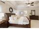 Stylish main bedroom featuring tray ceilings, a fan, and an ensuite bathroom at 4674 Lakeway Pl, Alpharetta, GA 30005
