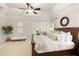 Comfortable and stylish main bedroom featuring tray ceilings, a fan and sitting area at 4674 Lakeway Pl, Alpharetta, GA 30005