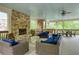 Outdoor living space featuring a fireplace, grill, and comfortable seating area at 4674 Lakeway Pl, Alpharetta, GA 30005