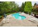 Refreshing private pool surrounded by lounge chairs and lush landscaping at 4674 Lakeway Pl, Alpharetta, GA 30005
