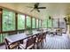 Inviting screened porch with dining area, comfortable seating, ceiling fans, and wooded views at 4674 Lakeway Pl, Alpharetta, GA 30005