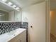 Modern bathroom with a stylish sink, decorative backsplash, and well-lit mirror for a fresh and clean look at 1812 Ashborough Se Cir # C, Marietta, GA 30067