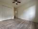 Inviting bedroom featuring hardwood flooring, a ceiling fan, and a spacious closet for storage at 1812 Ashborough Se Cir # C, Marietta, GA 30067
