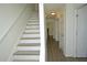 Bright hallway with wood flooring and a staircase leading to the upper level at 1812 Ashborough Se Cir # C, Marietta, GA 30067