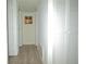 Hallway featuring louvered doors and new flooring at 1812 Ashborough Se Cir # C, Marietta, GA 30067