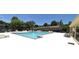 A large, bright blue community pool is surrounded by many lounge chairs near mulitple buildings at 1812 Ashborough Se Cir # C, Marietta, GA 30067