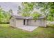 Exterior home view showcasing a well-manicured backyard, a concrete patio, and a neutral siding home at 2212 Chestnut Log Loop, Lithia Springs, GA 30122