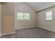 Cozy bedroom with neutral walls, carpeted floors, and natural light from two windows at 2212 Chestnut Log Loop, Lithia Springs, GA 30122