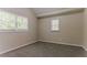 Bright bedroom with carpeted floors and natural light from two windows at 2212 Chestnut Log Loop, Lithia Springs, GA 30122