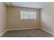 Bright bedroom featuring neutral walls and carpet, plus a well-lit window at 2212 Chestnut Log Loop, Lithia Springs, GA 30122