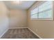 Neutral bedroom features plush carpet, a large window, and warm, inviting paint at 2212 Chestnut Log Loop, Lithia Springs, GA 30122