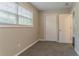 A cozy bedroom offers natural light, new carpet, and access to a closet at 2212 Chestnut Log Loop, Lithia Springs, GA 30122